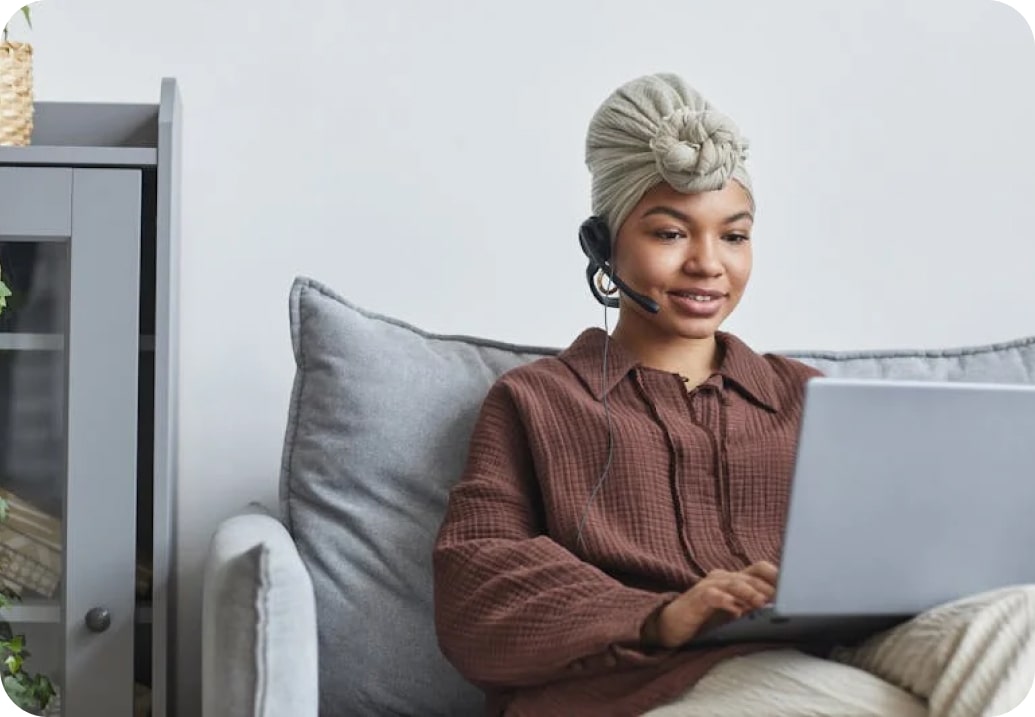 Woman seated with laptop representing premium support